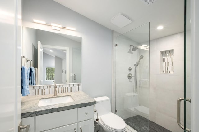 bathroom with vanity, toilet, an enclosed shower, and lofted ceiling