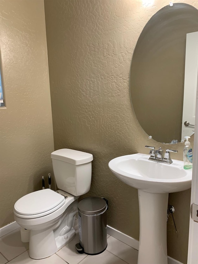 bathroom featuring tile patterned floors, toilet, and sink