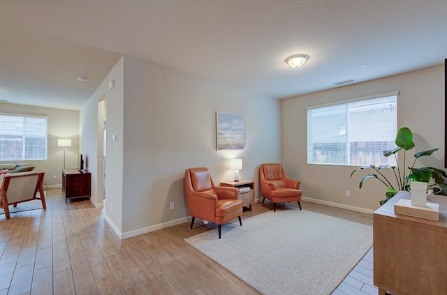 living area with light hardwood / wood-style floors