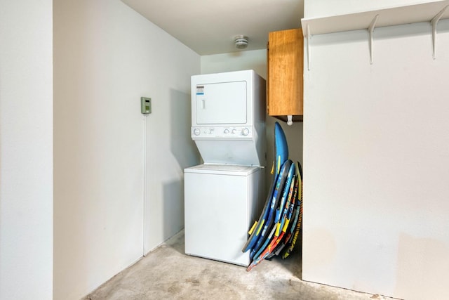 washroom featuring stacked washer / dryer