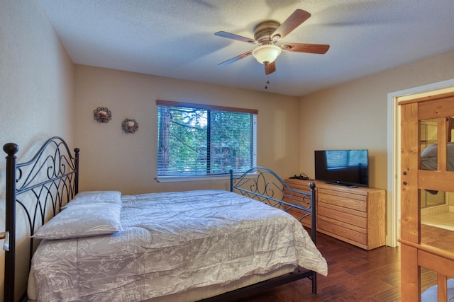 bedroom with a textured ceiling, dark hardwood / wood-style floors, and ceiling fan