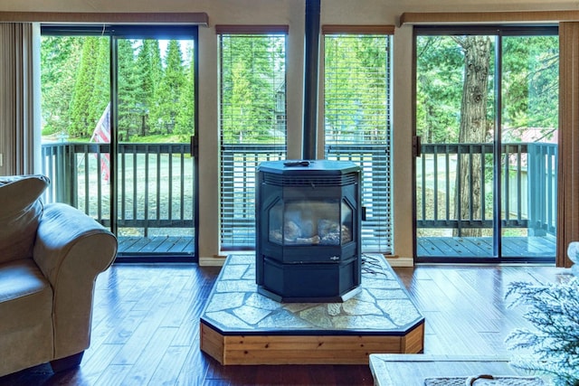 living room with wood-type flooring and a wood stove