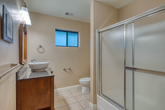 full bathroom with tile patterned flooring, vanity, toilet, and enclosed tub / shower combo