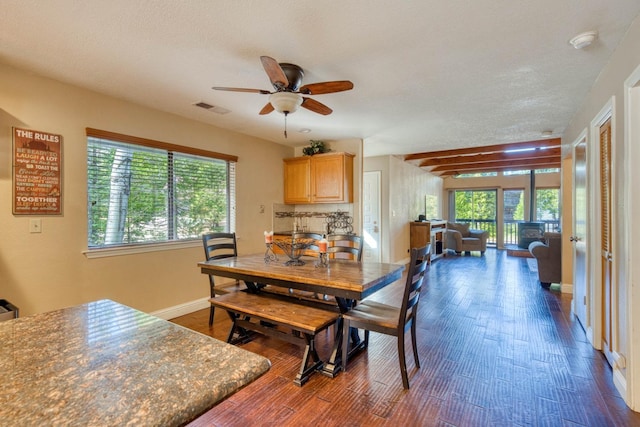 dining space featuring a textured ceiling, dark hardwood / wood-style floors, and ceiling fan