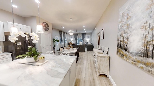 dining space featuring ceiling fan and light hardwood / wood-style floors