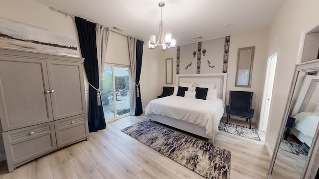 bedroom with light hardwood / wood-style floors, access to exterior, and a chandelier