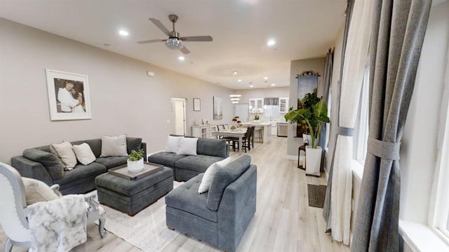 living room featuring ceiling fan and light wood-type flooring