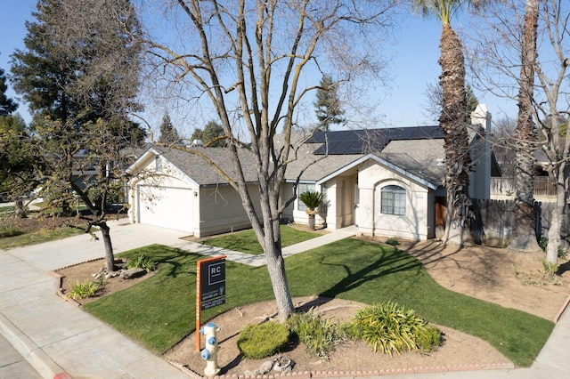 ranch-style house with a front yard and solar panels