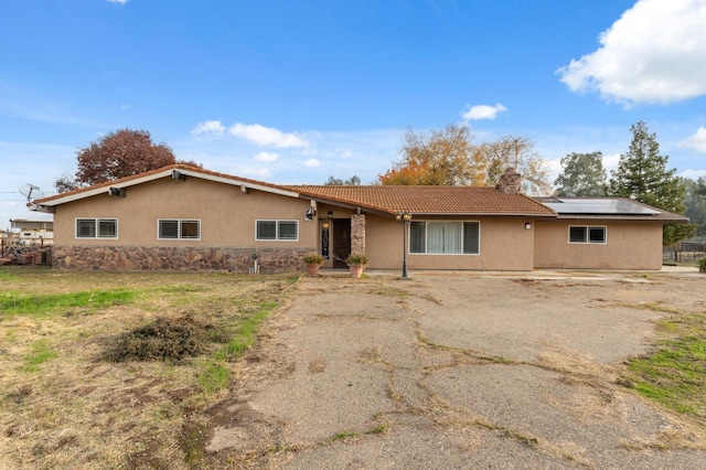 12713 Rd 37 Unit 1/2, Madera, CA 93636 - view of front of house featuring stucco siding, solar panels, a tile roof, and a chimney