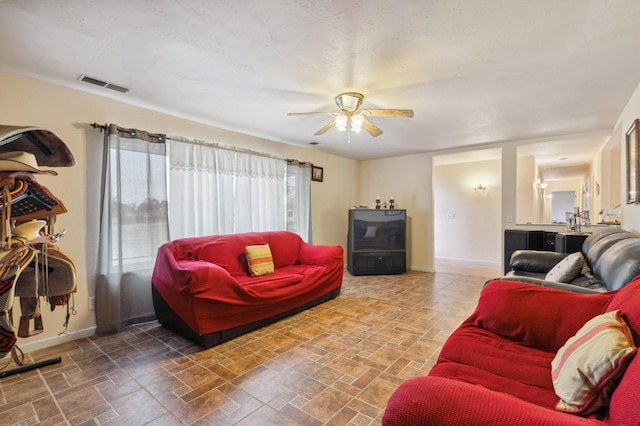 12713 Rd 37 Unit 1/2, Madera, CA 93636 - living room featuring ceiling fan and baseboards