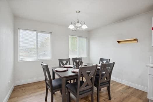 dining area featuring a notable chandelier and light hardwood / wood-style floors