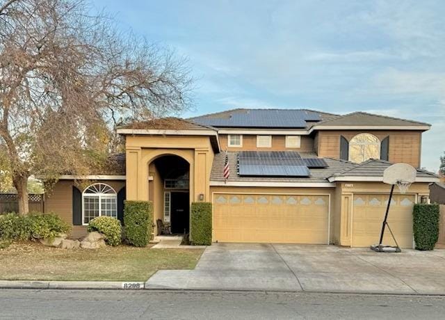 view of front of property with solar panels and a garage