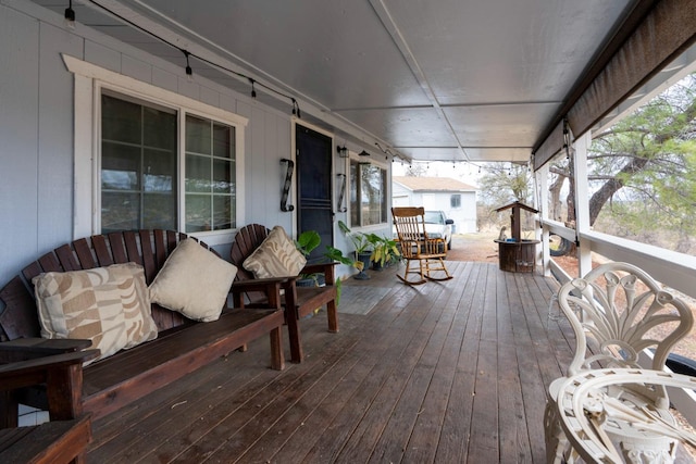 wooden terrace featuring covered porch