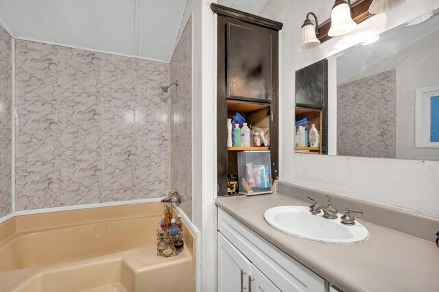 bathroom with a washtub and vanity