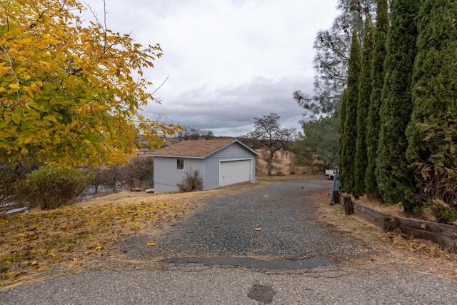 view of side of property featuring a garage and an outdoor structure