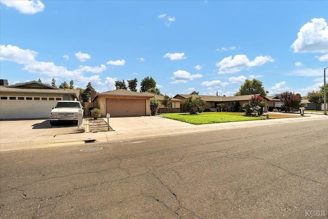 ranch-style house featuring a garage and a front lawn