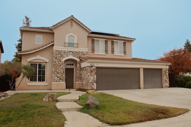 mediterranean / spanish house featuring solar panels and a garage