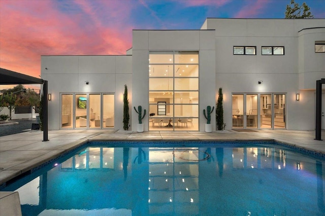 view of pool at dusk