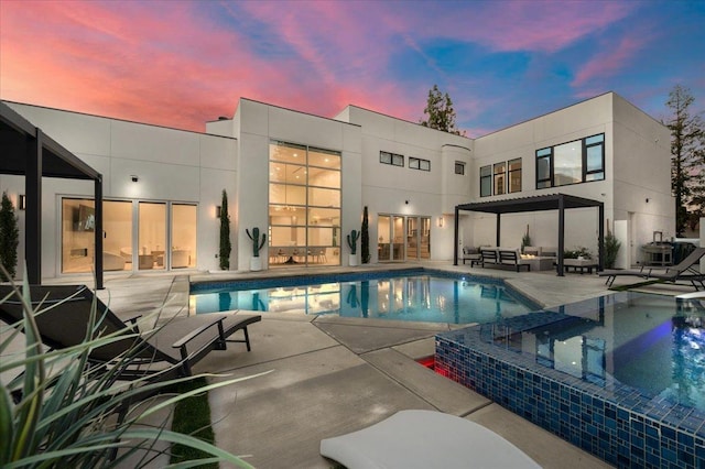 pool at dusk with a patio area and central air condition unit