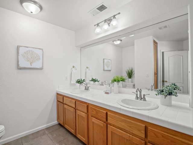 bathroom with vanity, tile patterned floors, and toilet