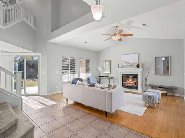 living room featuring high vaulted ceiling, light tile patterned floors, and ceiling fan