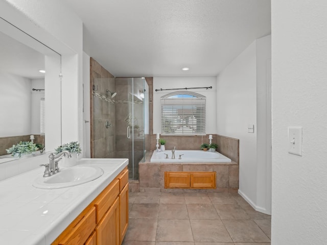 bathroom featuring shower with separate bathtub, a textured ceiling, vanity, and tile patterned floors