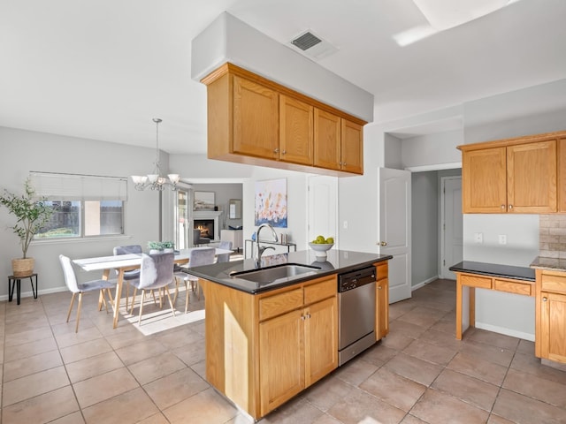 kitchen with pendant lighting, sink, dishwasher, an island with sink, and light tile patterned flooring