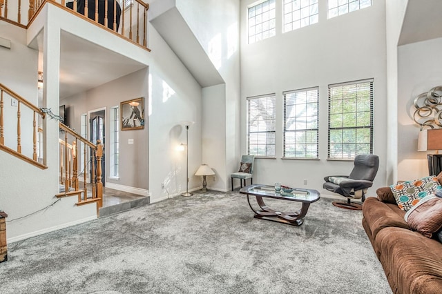 carpeted living room with a high ceiling