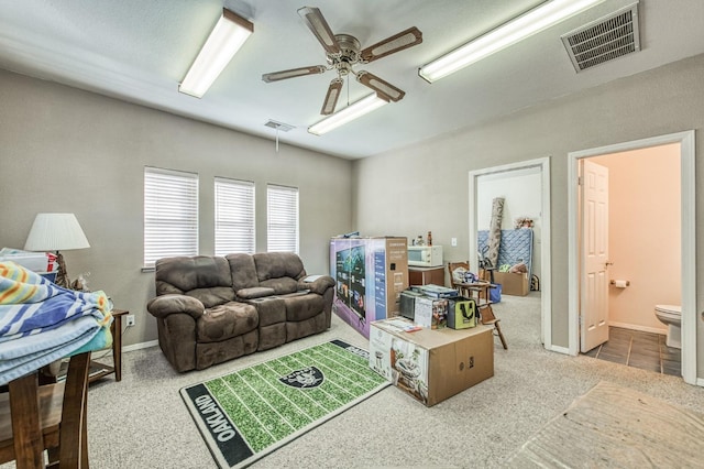 carpeted living room with ceiling fan