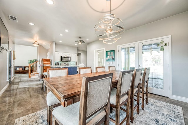 dining room with ceiling fan with notable chandelier and french doors