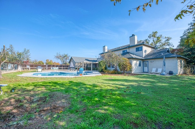 view of yard featuring a fenced in pool and a patio