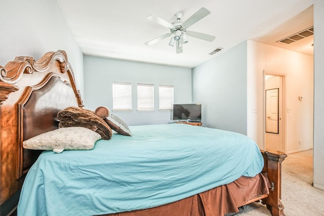 bedroom with ceiling fan and light carpet