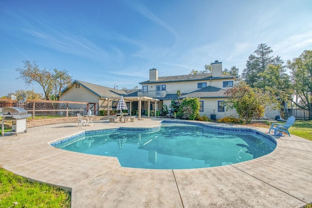 view of swimming pool with a patio area