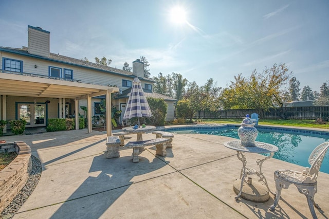 view of pool featuring a patio area and french doors