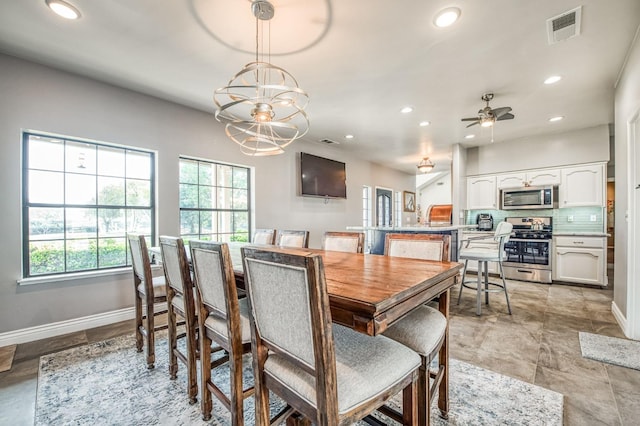 dining room featuring ceiling fan with notable chandelier