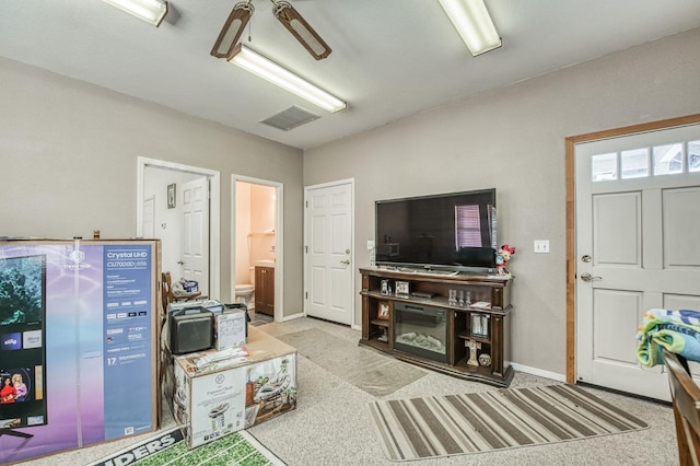 carpeted living room featuring ceiling fan