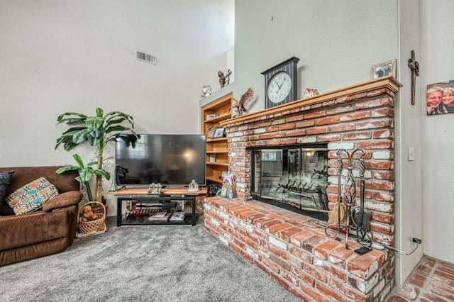 carpeted living room with a brick fireplace