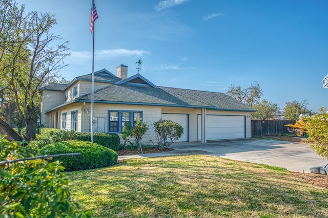 view of front of house featuring a front yard and a garage