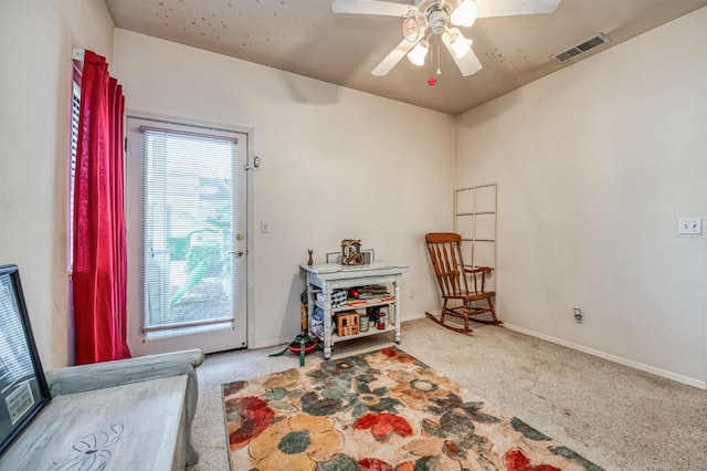 sitting room featuring ceiling fan and carpet floors