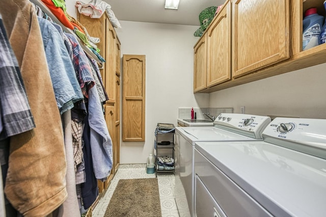 washroom featuring cabinets and independent washer and dryer