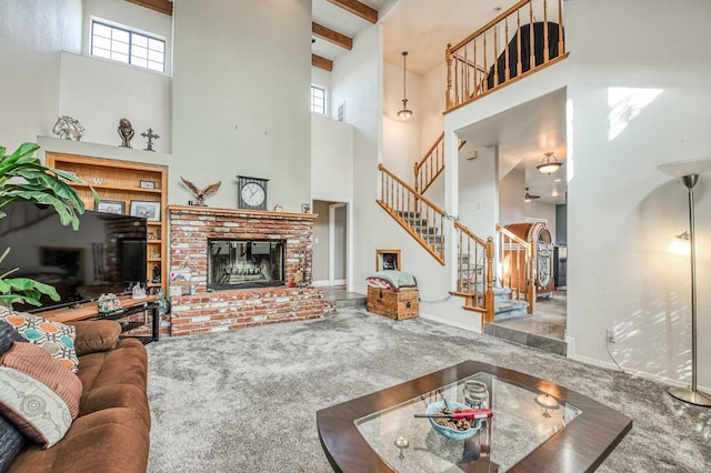 living room featuring carpet, a healthy amount of sunlight, and a towering ceiling