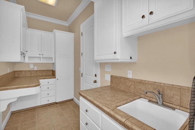 kitchen featuring tile countertops, white cabinets, and sink