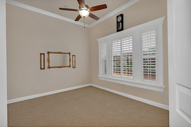 carpeted spare room featuring ceiling fan and ornamental molding