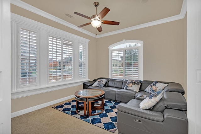 living room with a wealth of natural light, crown molding, and carpet