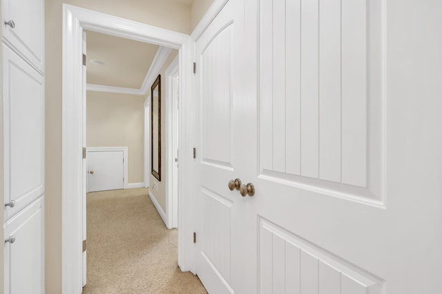 hall featuring light carpet and crown molding