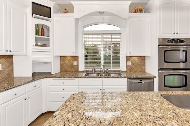 kitchen with stainless steel appliances, white cabinetry, and sink