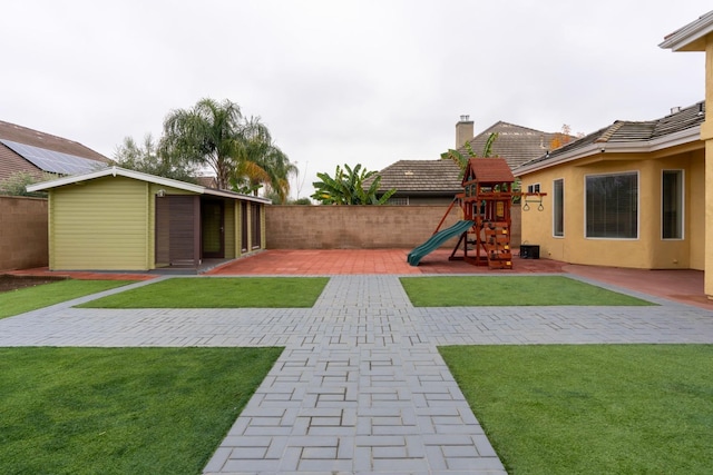 view of yard featuring a playground and a patio area