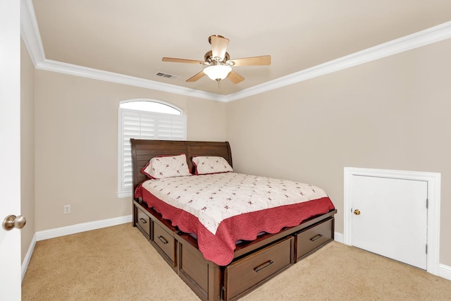 bedroom with ceiling fan, light colored carpet, and crown molding