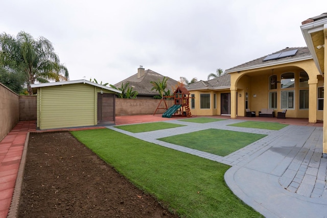 view of yard with a playground, a patio area, and an outdoor living space