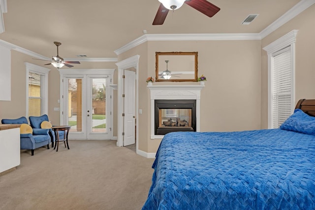 carpeted bedroom with access to exterior, crown molding, and ceiling fan